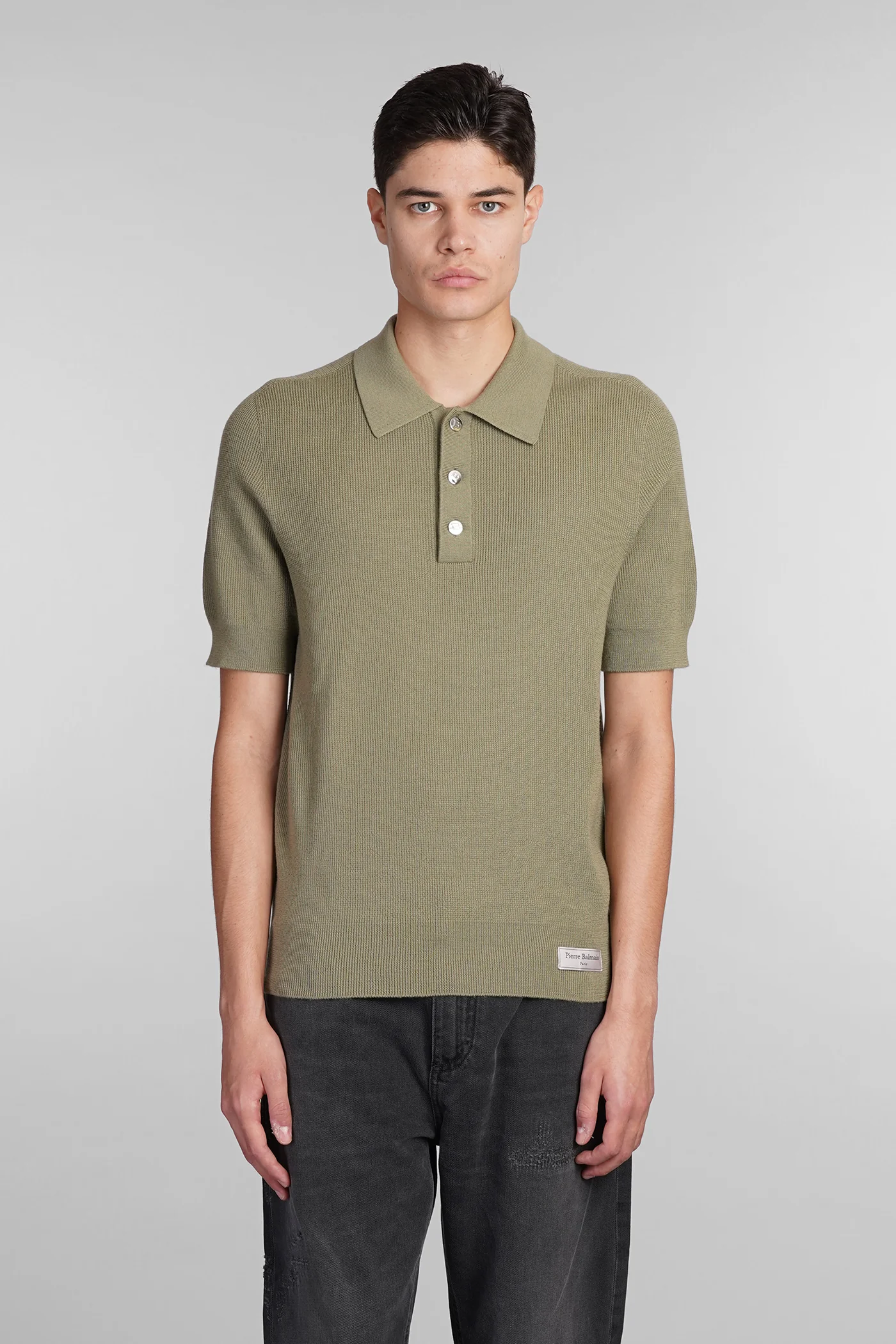 Polo in green wool